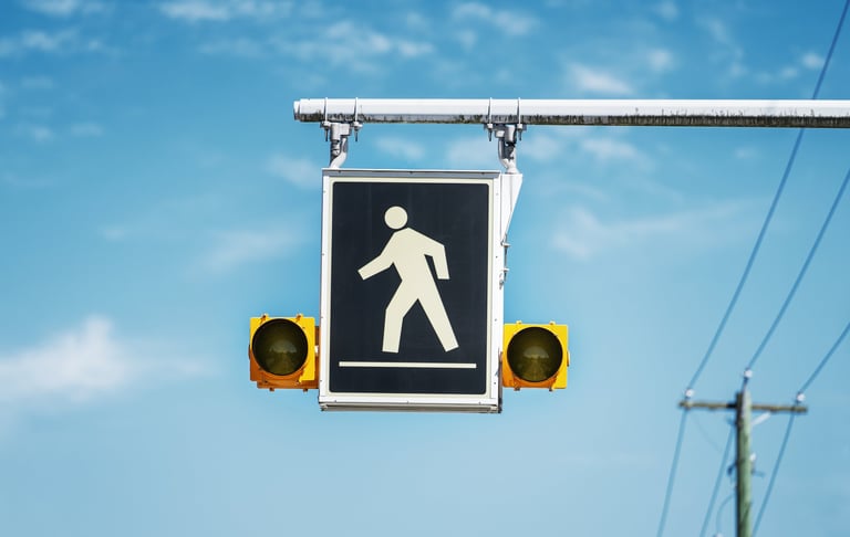 Pedestrians on the road, warning sign on the street in Canada
