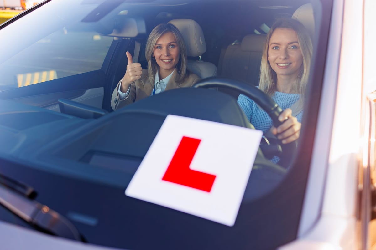 Professional driving lessons in Surrey BC — ICBC certified instructor and student giving thumbs up after successful driving lesson