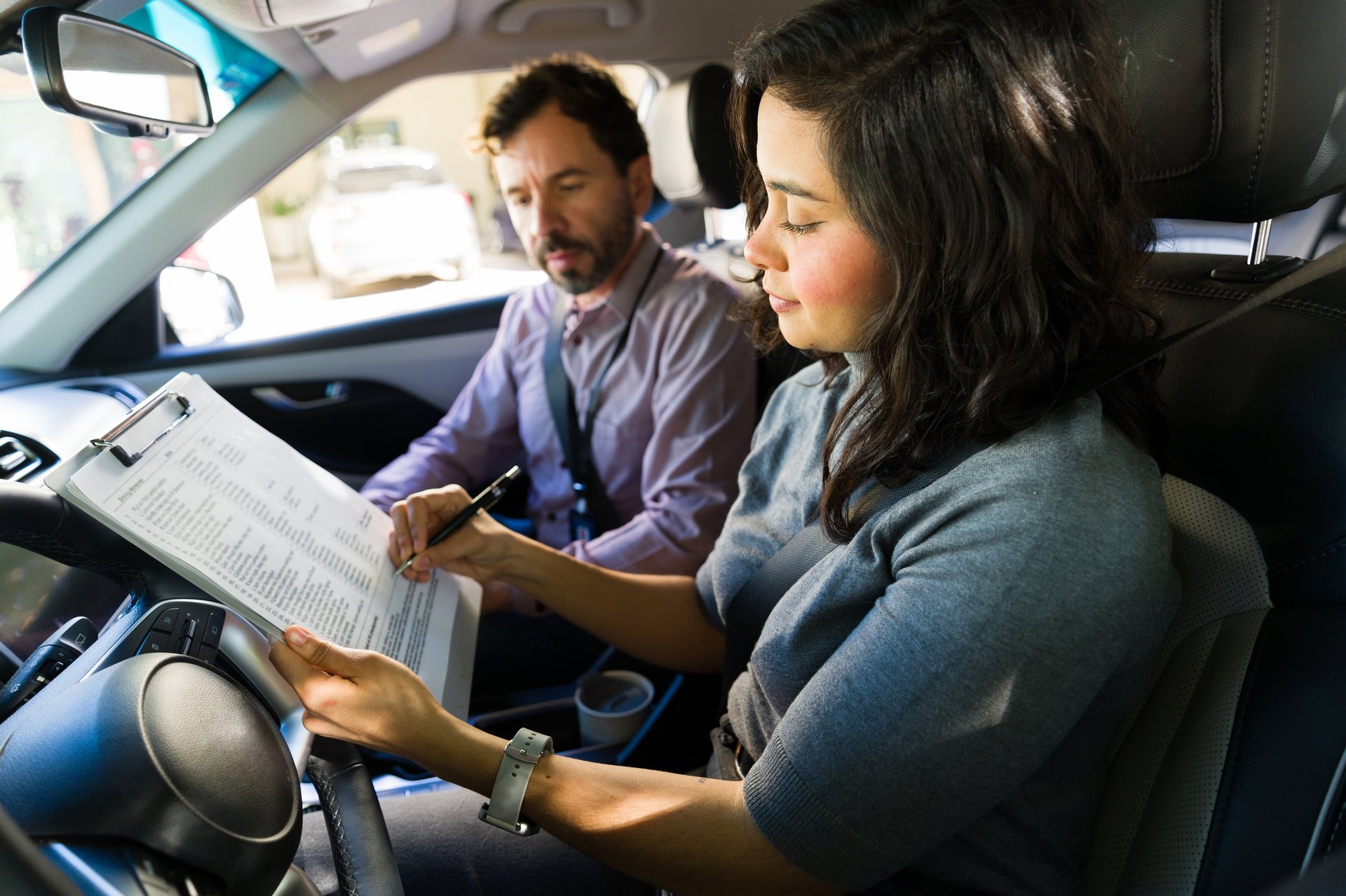 Student reviewing her driver's license checklist with a certified driving instructor during an ICBC road test prep lesson in Delta BC
